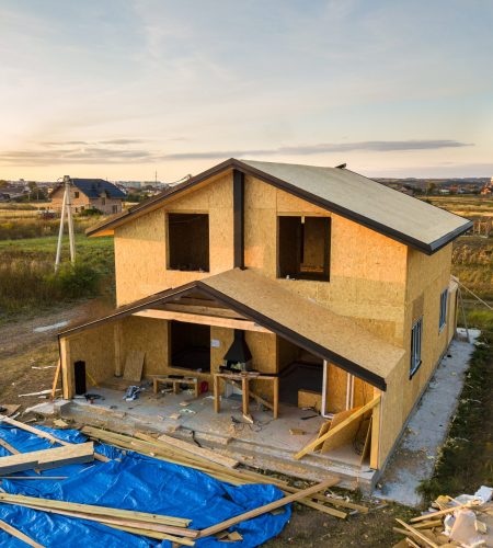 Construction of new and modern modular house. Walls made from composite wooden sip panels with styrofoam insulation inside. Building new frame of energy efficient home concept.
