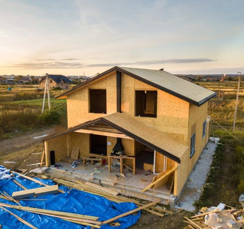 Construction of new and modern modular house. Walls made from composite wooden sip panels with styrofoam insulation inside. Building new frame of energy efficient home concept.